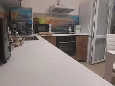 a kitchen with a white counter top and a refrigerator at Summer Burgas Appartment in Burgas City