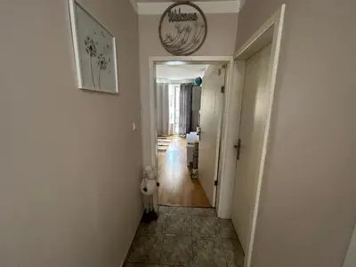 a hallway leading into a home with a clock on the wall at Luxury Apartments Ani in Burgas City