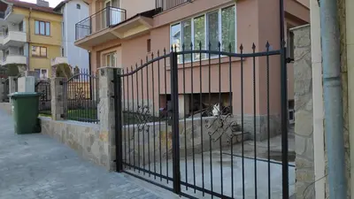 a black metal fence in front of a building at Къща за гости Снежа/ Guest house Snezha in Obzor