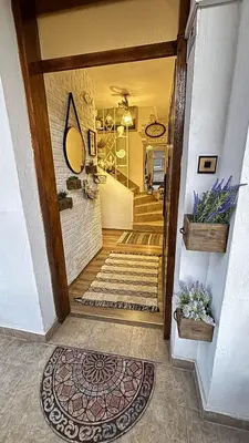 a hallway of a home with a staircase and a door at Guest house Hei taka in Sozopol