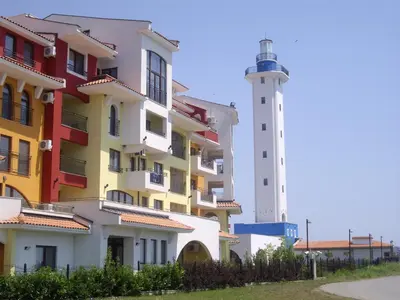a building next to a lighthouse next to a building at STUDIO DELUXE IN MARINA CAPE 4 stars complex 33 7 in Aheloy