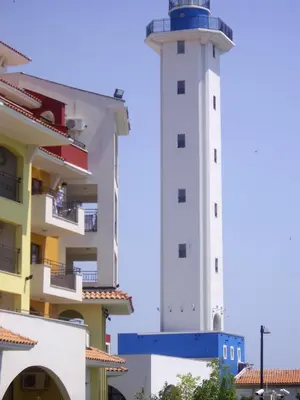 a lighthouse next to a building next to a building at STUDIO DELUXE IN MARINA CAPE 4 stars complex 33 7 in Aheloy