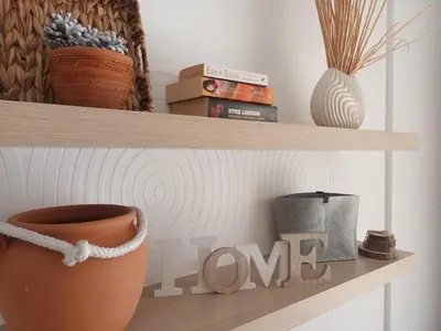 a shelf with a vase and books on it at STUDIO DELUXE IN MARINA CAPE 4 stars complex 33 7 in Aheloy
