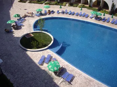 a swimming pool with lawn chairs and umbrellas at APARTMENT DELUXE MARINA CAPE 4 stars complex 33 6 in Aheloy