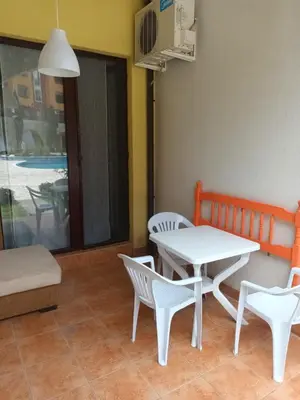a table and chairs in a room with a table at APARTMENT DELUXE MARINA CAPE 4 stars complex 33 6 in Aheloy
