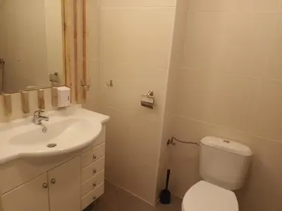 a bathroom with a white toilet and a sink at APARTMENT STUDIO DELUXE MARINA CAPE 4 stars resort 33 5 in Aheloy