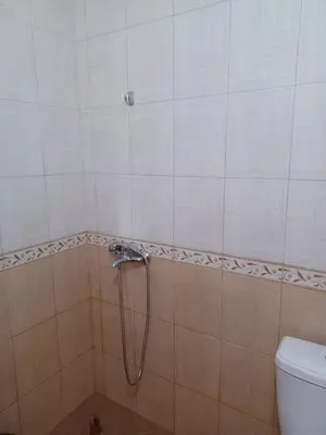 a shower in a bathroom with a toilet at Апартамент Желева in Pomorie