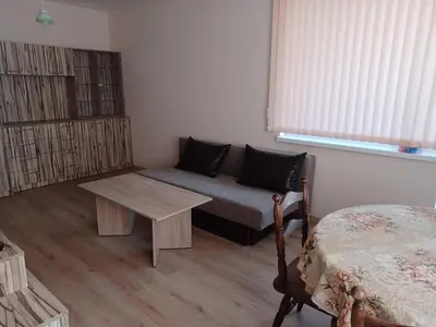a living room with a couch and a table at Апартамент Желева in Pomorie