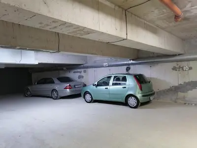 two cars are parked in a parking garage at Апартамент Даскала с паркомясто in Burgas City