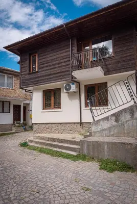 a house with a balcony on the side of it at Къща за гости Димови in Sozopol