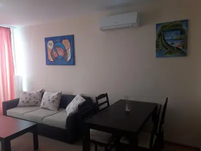 a living room with a couch and a table at Gradina Sunny Deluxe apartment in Sozopol