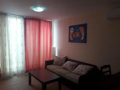 a living room with a couch and a table at Gradina Sunny Deluxe apartment in Sozopol