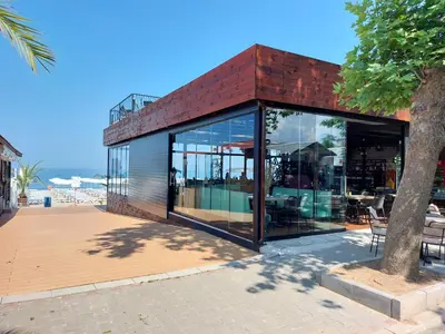 a glass house with a red brick roof at SAPPHIRE in Sozopol