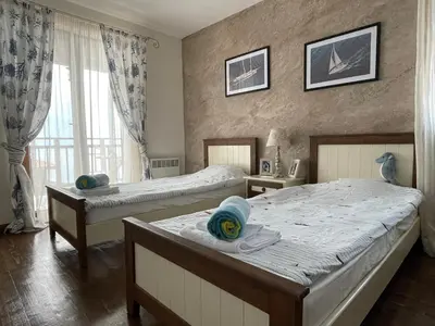 a bedroom with two beds and a window at Sozopolis Cliffs Luxury Seaview Villa in Sozopol