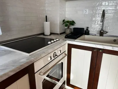 a kitchen with a stove and a sink at Sozopolis Cliffs Luxury Seaview Villa in Sozopol