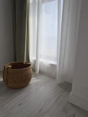 a wicker basket sitting in front of a window at Gold beach apart Obzor in Obzor