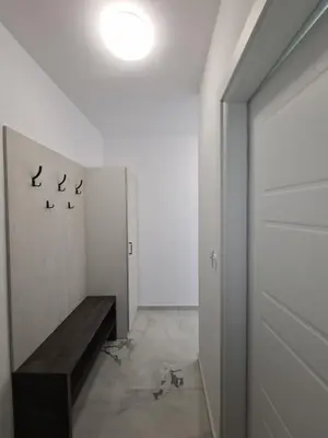 a hallway with a bench in a white room at Gold beach apart Obzor in Obzor