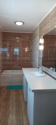 a bathroom with a white sink and a tub at Swan Bay complex in Chernomorets