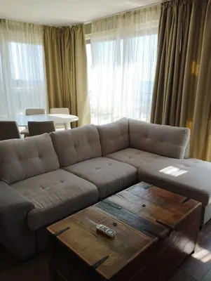 a living room with a couch and a coffee table at Swan Bay complex in Chernomorets