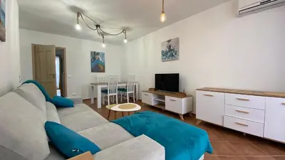 a living room with a couch and a tv at KALIA A16 Private One Bedroom Apartment in Sunny Beach