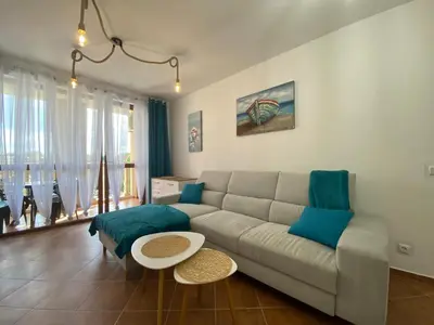 a living room with a couch and a table at KALIA A16 Private One Bedroom Apartment in Sunny Beach