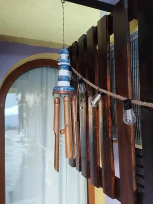 a chandelier made out of old baseball bats at Casa do Farol - апартамент с басейн до плажа на къмпинг 
