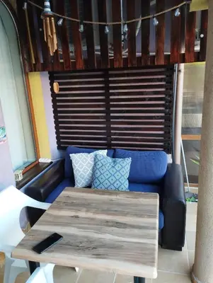 a living room with a couch and a table at Casa do Farol - апартамент с басейн до плажа на къмпинг 