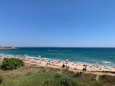 a group of people on a beach with the ocean at Villa Rouge - Apartment Victoria in Sozopol