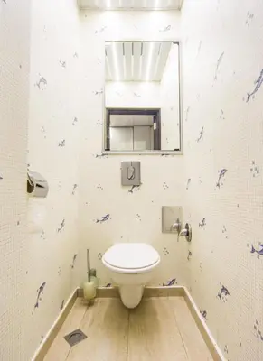 a bathroom with a toilet and a mirror at Tsarigradska in Burgas City