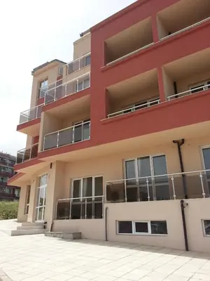 an apartment building with balconies and a parking lot at Hotel Ray in Sozopol