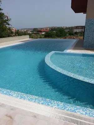 a large swimming pool with blue water on a building at Hotel Ray in Sozopol