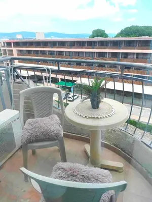 a patio with a table and chairs on a balcony at Sunrise Studio Grenada in Sunny Beach