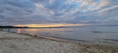 a beach with a cloudy sky and the water at Eve Santa Marina Apartments - sea, pools, relax in Sozopol