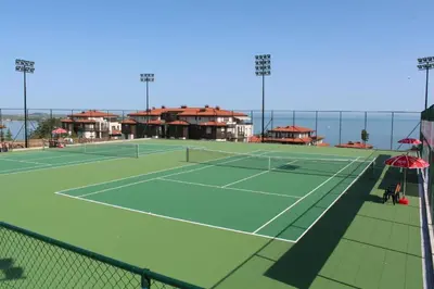 a tennis court with a tennis court at Eve Santa Marina Apartments - sea, pools, relax in Sozopol