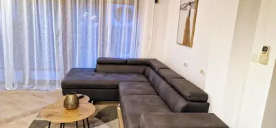 a living room with a couch and a table at Eve Santa Marina Apartments - sea, pools, relax in Sozopol