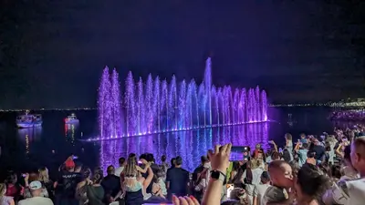 a crowd of people standing in front of a fountain at Brisa Apartment in Burgas City