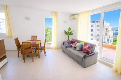 a living room with a couch and a table at Sunset Dream Polo Resort in Sunny Beach
