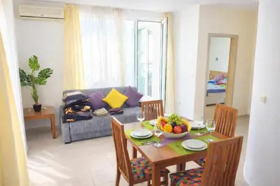 a living room with a table with a bowl of fruit at Sunset Dream Polo Resort in Sunny Beach