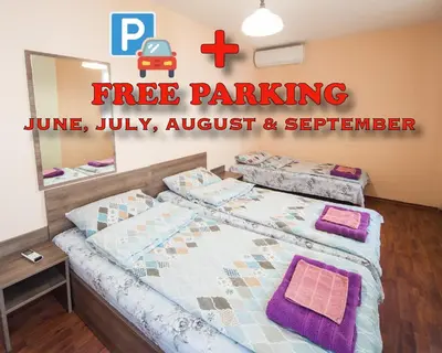 a bedroom with two beds and a sign that reads free parking at SUMMER LAZUR - Sunny Flat with 2 separate rooms in Burgas City