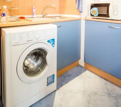 a washing machine in a kitchen with a sink at SUMMER LAZUR - Sunny Flat with 2 separate rooms in Burgas City