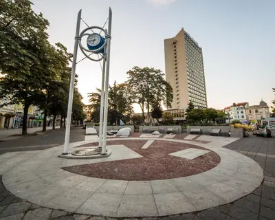 a clock in the middle of a circle in a city at SUMMER LAZUR - Sunny Flat with 2 separate rooms in Burgas City