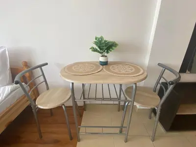 a small table with two chairs and a potted plant on it at SUMMER BREEZE 503 Private Studio SUNNY BEACH in Sunny Beach