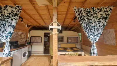 a kitchen in an rv with curtains and a table at Каравана Амалтея in Sozopol