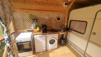 a kitchen with a washing machine in an rv at Каравана Амалтея in Sozopol