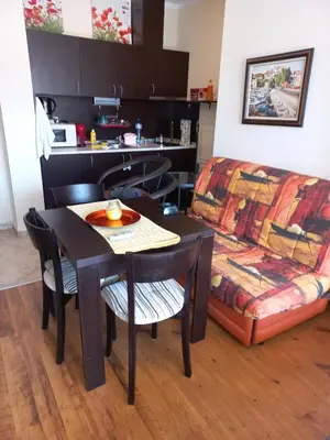a dining room with a table and a couch at Sozopoly studio in Sozopol
