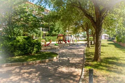 a park with a playground and a tree at Sozopoly studio in Sozopol