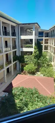 a large apartment building with a brick walkway in front of it at Sozopoly studio in Sozopol