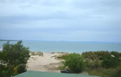 a view of a beach with a car on the sand at Sozopoly studio in Sozopol