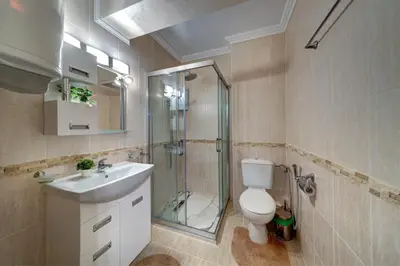 a bathroom with a shower and a toilet and a sink at Luxe Apartment Olymp in Sveti Vlas in Sveti Vlas