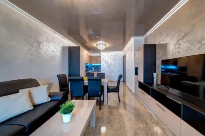 a living room with a couch and a table at Luxe Apartment Olymp in Sveti Vlas in Sveti Vlas